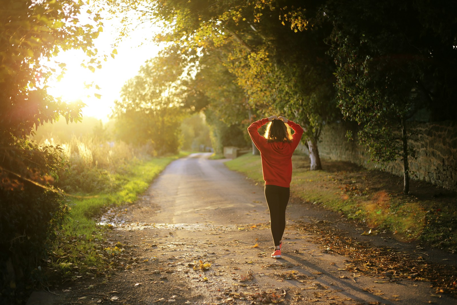 woman walking on pathway during daytime